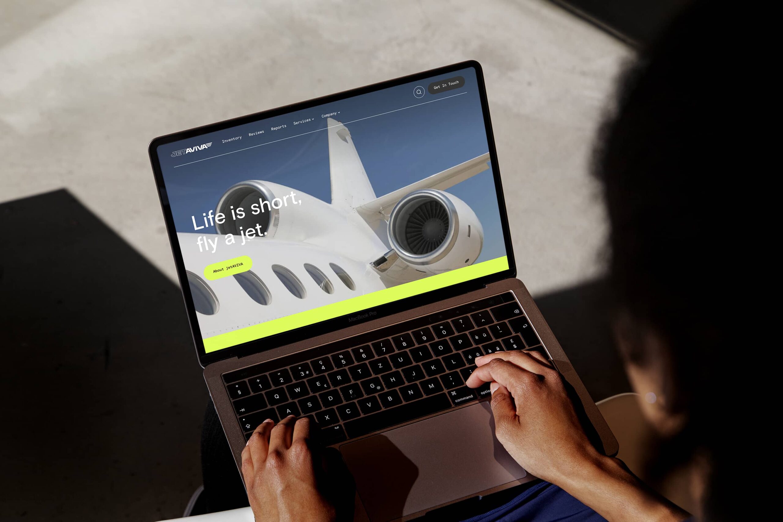 A woman viewing the JetAviva web design by the agency This January